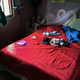 A baby sleeps while his parents work in the marijuana field.